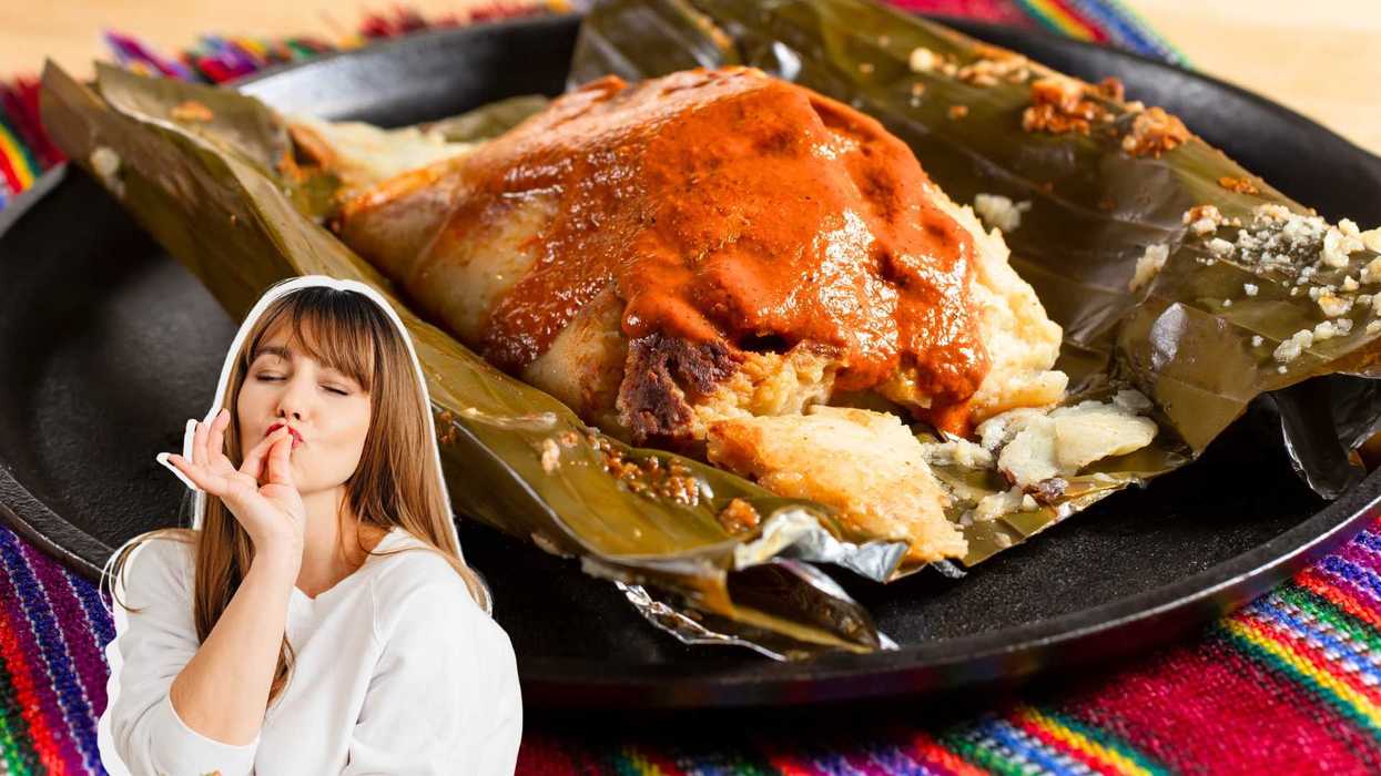 Tamale with sauce on banana leaf, woman gesturing delight in foreground.