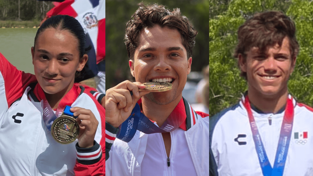 Three athletes smiling, wearing medals and sports jackets outdoors.