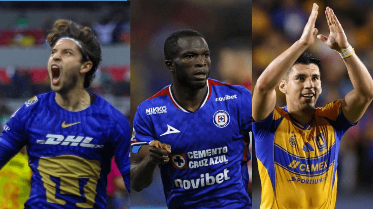 Three soccer players in blue and yellow jerseys on the field.