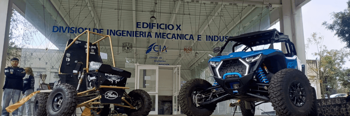 Two off-road vehicles displayed outside an engineering building.