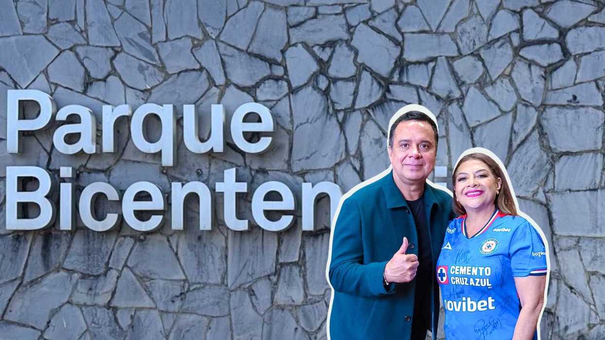 Two people smiling in front of a stone wall with "Parque Bicentenario."