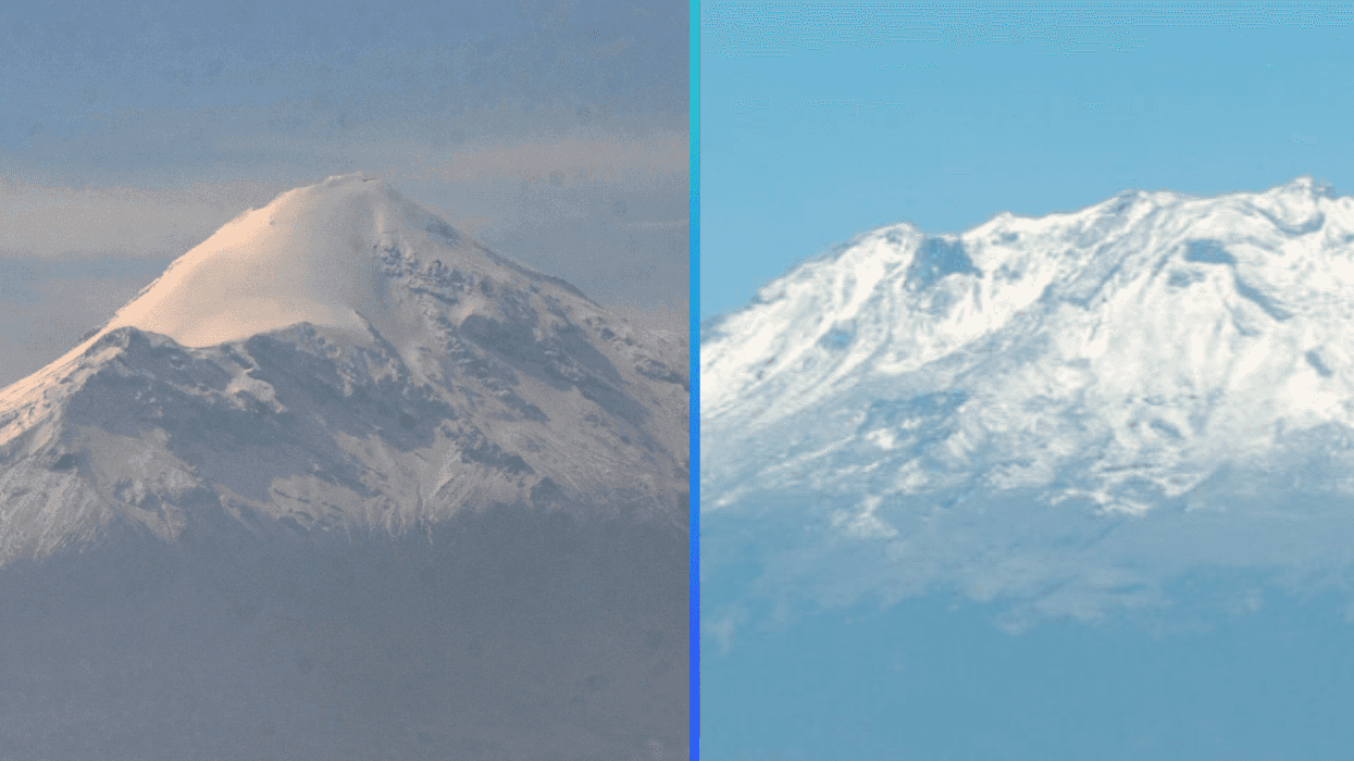 Two snow-covered volcanoes side by side under a clear blue sky.