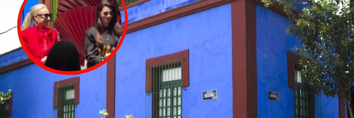 Vibrant blue building with inset photo of two people in colorful attire.