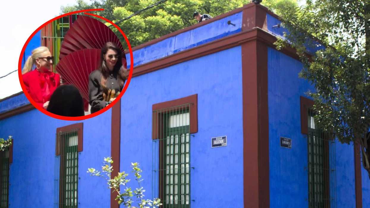 Vibrant blue building with inset photo of two people in colorful attire.