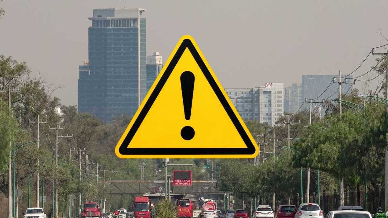 Warning sign overlay on smoggy urban cityscape with traffic.