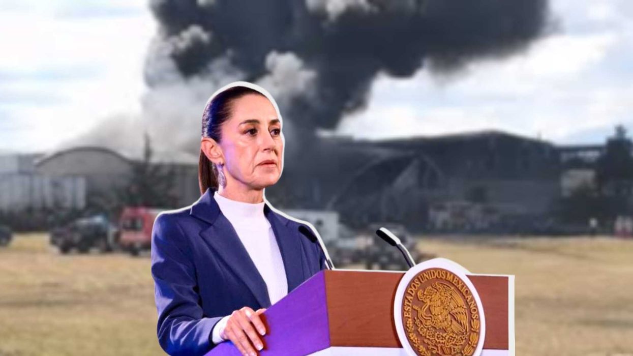 Woman at podium with smoke billowing in background.