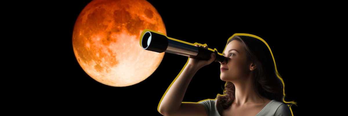 Woman looking through telescope at large orange moon on black background.