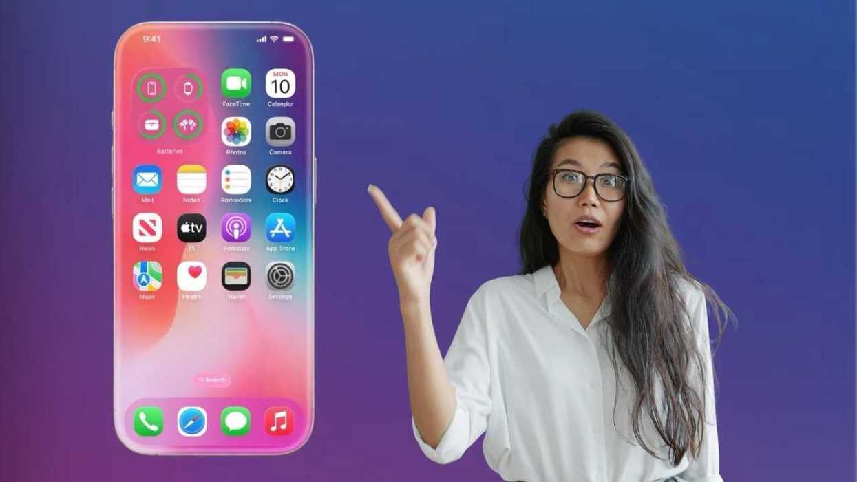 Woman pointing at large smartphone display on purple gradient background.