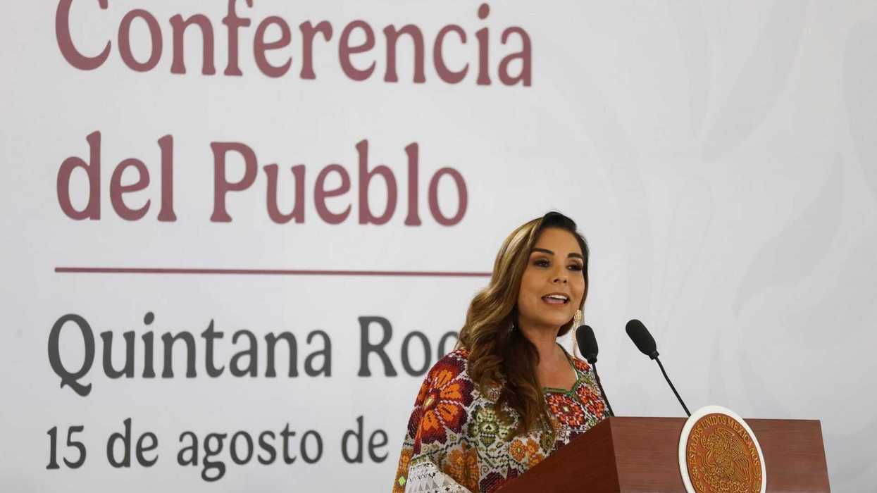 Woman speaking at a podium during a conference in Quintana Roo, August 15.