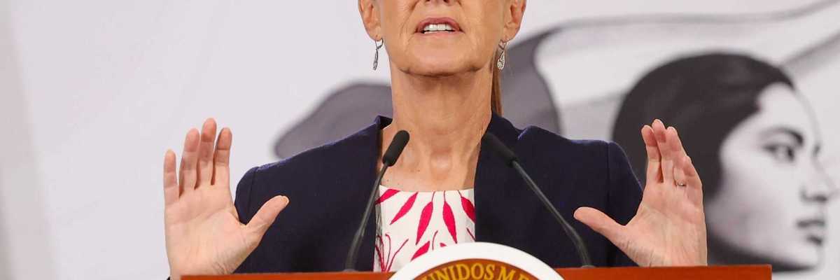 Woman speaking at a podium featuring the Mexican seal.