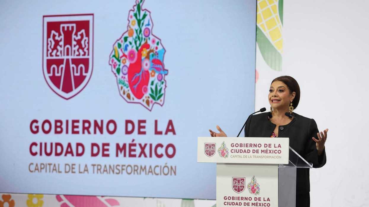 Woman speaking at a podium, Mexico City government logos behind.