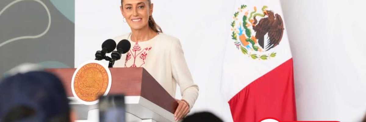 Woman speaking at a podium with a Mexican flag, live event indication.