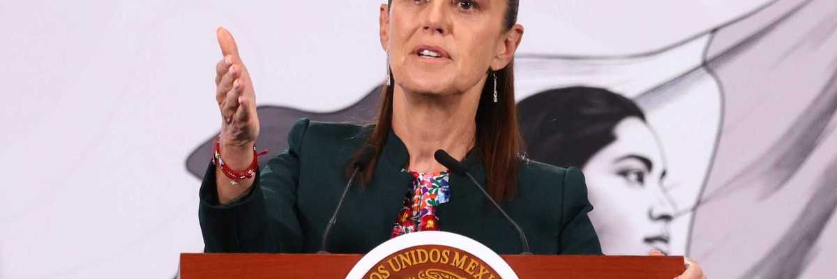 Woman speaking at a podium with the Mexican seal, background portrait visible.