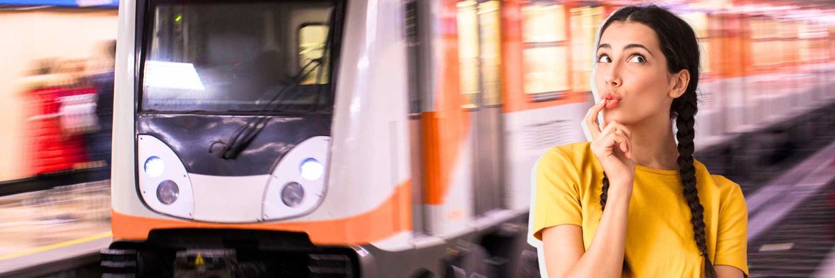 Woman thinking in a subway station with an approaching train.