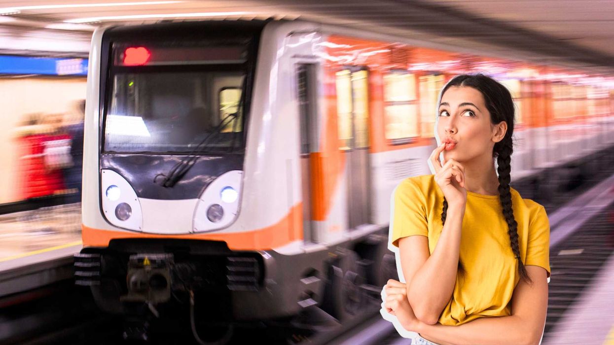 Woman thinking in a subway station with an approaching train.