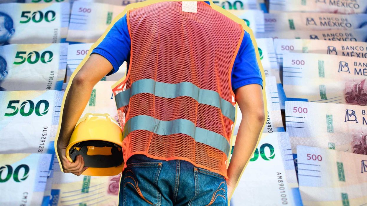 Worker in a safety vest holds a helmet against a background of Mexican 500 peso bills.