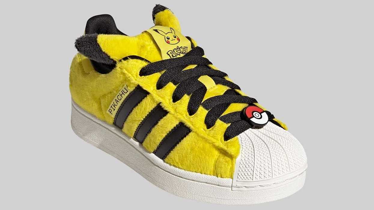 Yellow Pikachu-themed sneaker with black stripes and Poké Ball lace decoration.